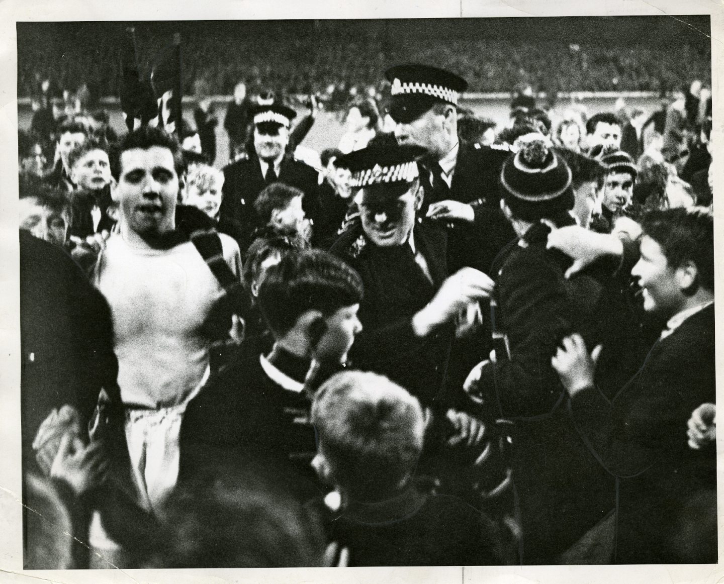 Goalkeeper Pat Liney is mobbed by fans.