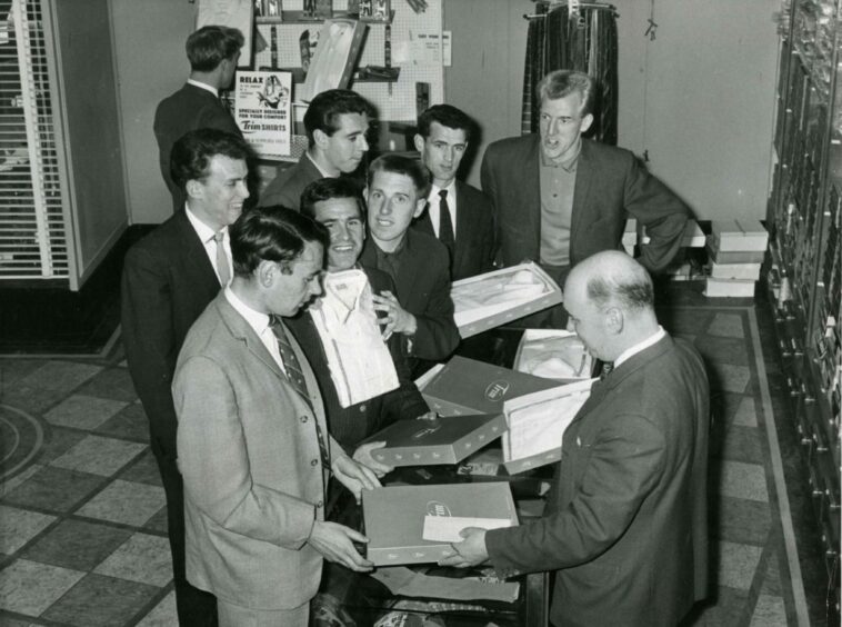 The Dundee players are fitted for new shirts ahead of the journey to New York in 1962.