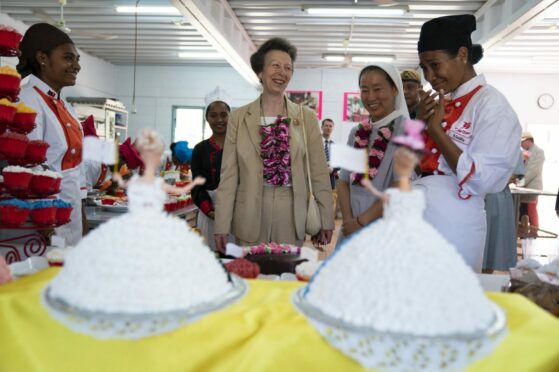 The Princess Royal looks at Barbie cakes during a visit to the Cooking Laboratory at Caritas Technical Secondary School, an all-girl boarding school for 700 students run by the Catholic Church in Port Moresby, on day two of the royal trip to Papua New Guinea on behalf of the Queen, in celebration of the Platinum Jubilee. Kirsty O'Connor/PA Wire