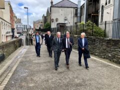 Congressman Richard Neal (left) talks to Derry city centre manager Jim Roddy (centre) at the historic city walls in Derry (David Young/PA)