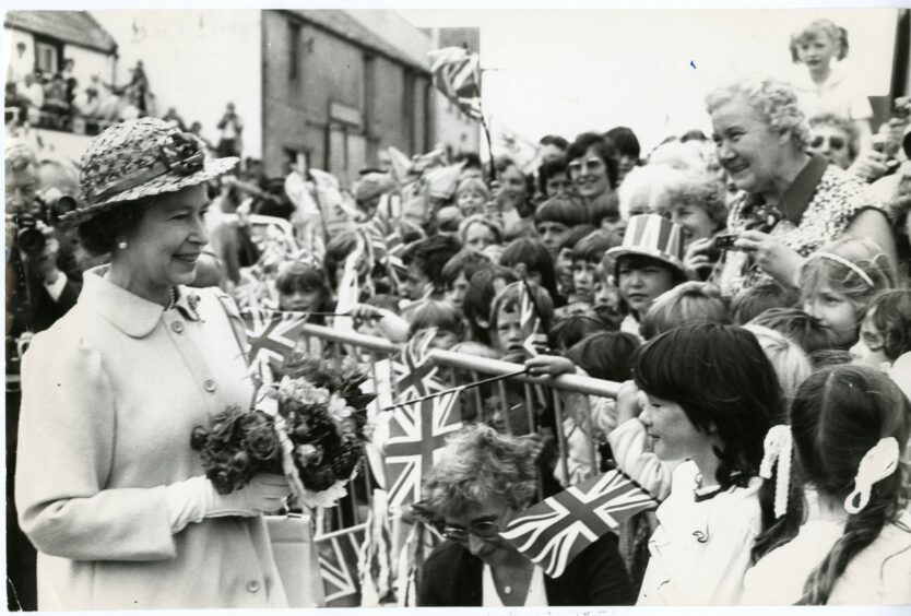 Her majesty is greeted by crowds and children in Cellardyke.