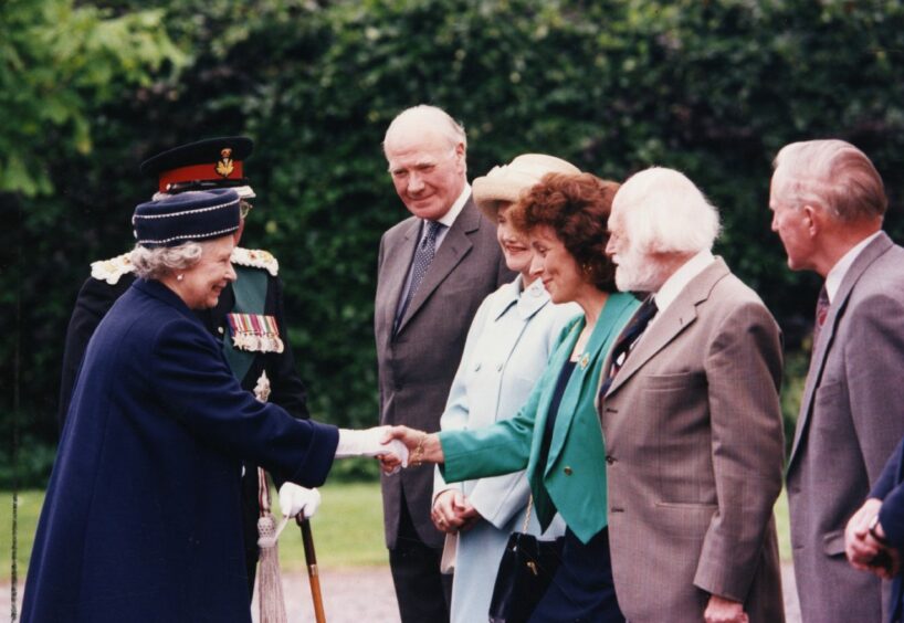 The Queen is greeted by dignitaries at Letham Hall. 