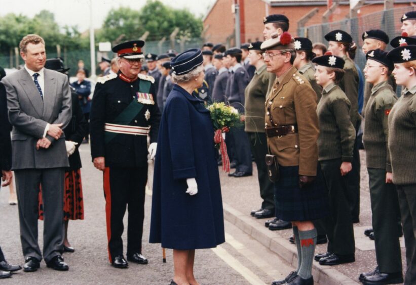 The Queen with Lieutenant Tony Robb, Ypres Company, Black Watch Army Cadets, at Forbo Nairn factory, Kirkcaldy