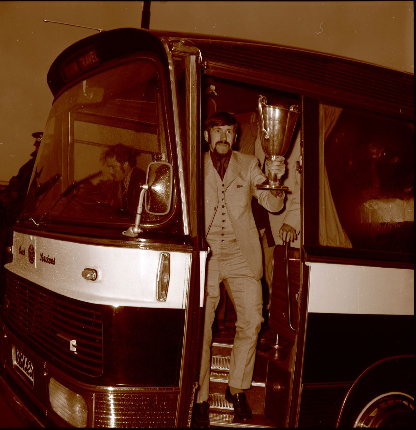 Rangers captain John Greig gets off the team bus with the club's first European trophy back in 1972.