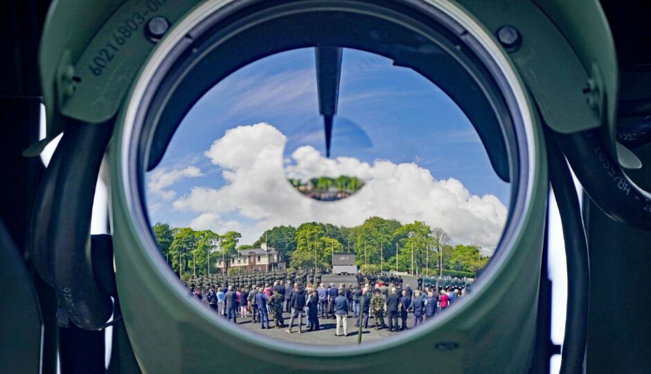 A reflection of crowds is seen in the camera lens of a remotely operated machine gun turret during a ceremony to mark the centenary of the handover of the Curragh Camp in Co Kildare, from British to Irish Forces. Niall Carson/PA Wire.