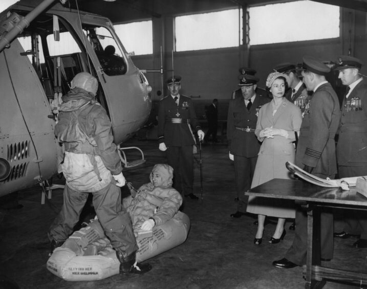 The Queen and Duke of Edinburgh watching a helicopter demonstration during a visit to RAF Leuchars. 