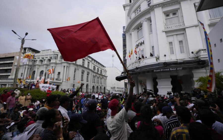 Members of Socialist Youth Union shout slogans, blocking the entrance to Sri Lanka's police headquarters, during a protest in Colombo, Sri Lanka. AP Photo/Eranga Jayawardena.
