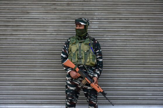 A paramilitary trooper stands on guard during a shutdown observed against former India's Bharatiya Janata Party