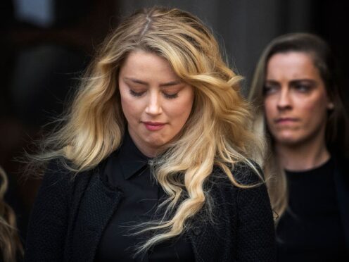 Actress Amber Heard, alongside her sister Whitney Henriquez, as she gives a statement outside the High Court in London (Victoria Jones/PA)