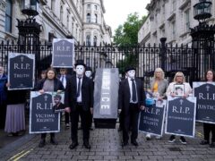 Representatives from Relatives for Justice, whose loved ones were murdered during the Troubles, protest in Parliament Square earlier this year (PA)