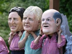 Activists from Oxfam wear giant heads depicting G7 leaders during a demonstration in Munich, Germany (Matthias Schrader/AP)