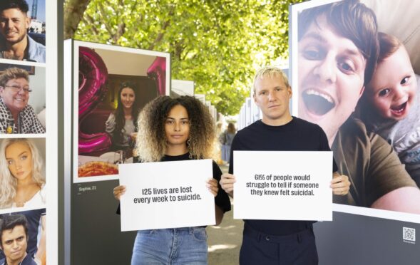 Amber Gill and Jamie Laing at the unveiling of a photo installation on London's Southbank showing the final photos taken of people before they took their own life by suicide prevention charity Campaign Against Living Miserably.