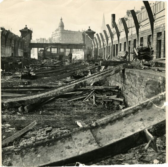 The remains of the demolished Dundee East Station, with a view of the building on the corner of Candle Lane and the spire at St Paul's Cathedral through the rubble from January 1964.