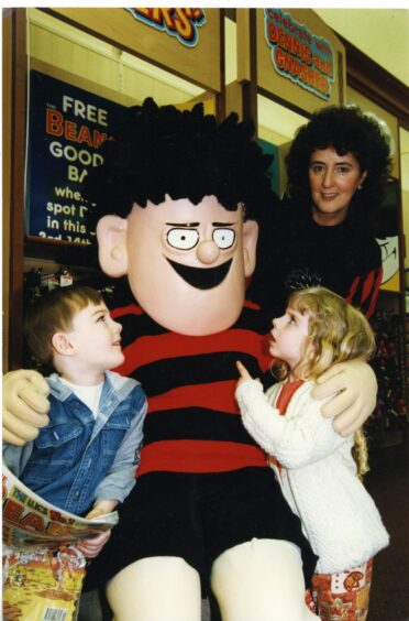 Dennis the Menace sits with some of his fans while visiting Marks and Spencer in Dundee in 1996.