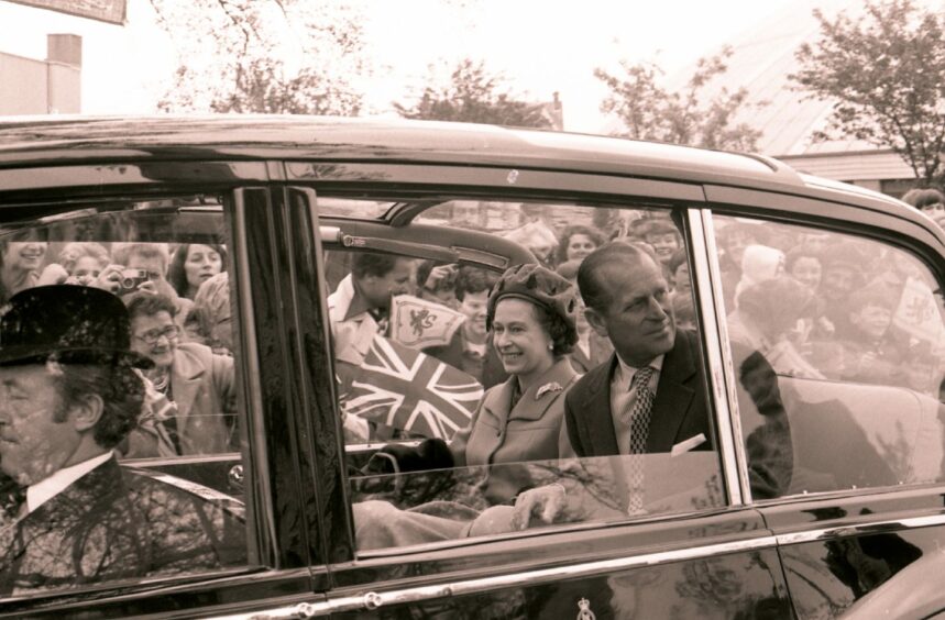 The royal couple look delighted as they receive the cheers of the crowd.