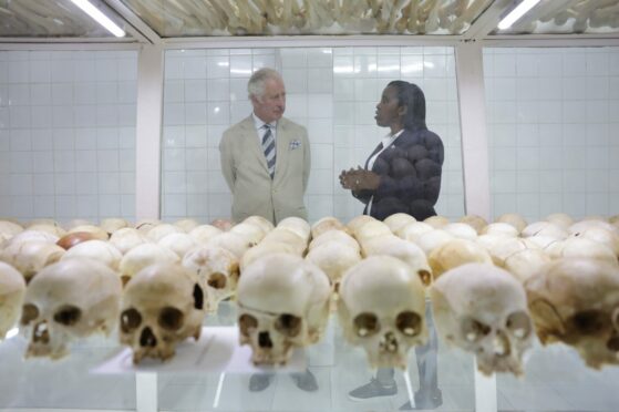 Manager Rachel Murekatete shows the Prince of Wales skulls of victims during his visit to the Nyamata Church Genocide Memorial, as part of his visit to Rwanda.