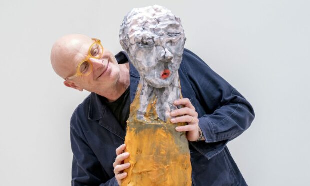 Artist Daniel Silver alongside some of his clay sculptures
