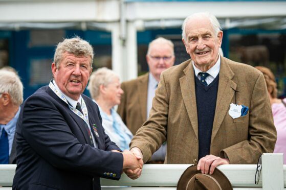 Charolais breeder Andrew Hornell congratulates Major Walter on his award.