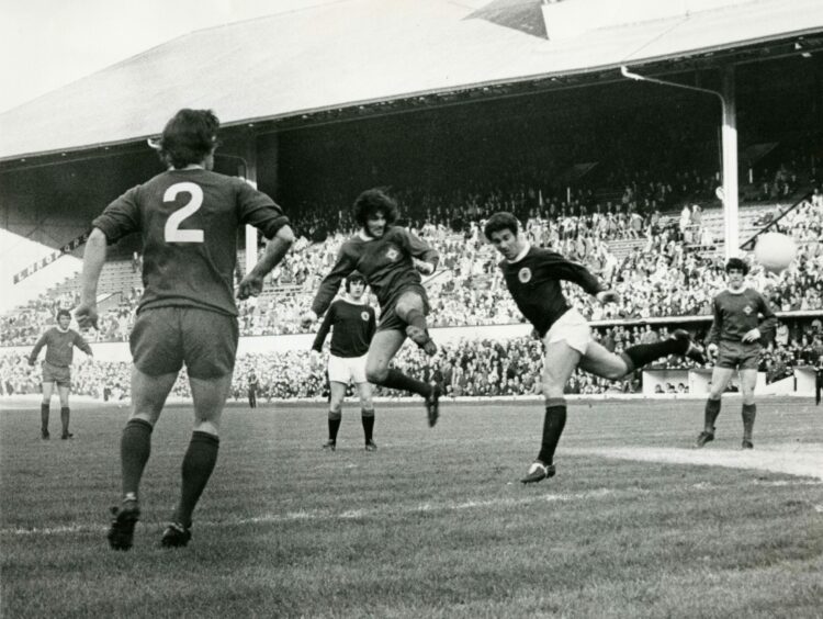 George Best puts in a header while playing for Northern Ireland against Scotland at Hampden Park in 1971.