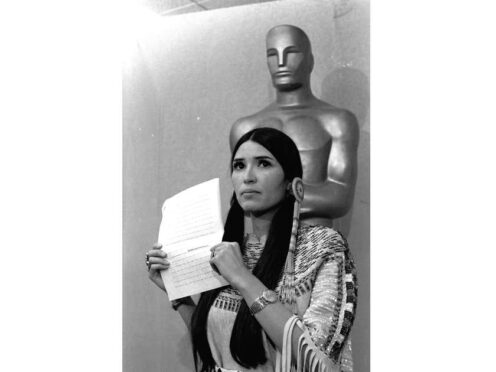 FILE – Sacheen Littlefeather appears at the Academy Awards ceremony to announce that Marlon Brando was declining his Oscar as best actor for his role in “The Godfather,” on March 27, 1973. The move was meant to protest Hollywood’s treatment of American Indians. Nearly 50 years later, the Academy of Motion Pictures Arts and Sciences has apologized to Littlefeather for the abuse she endured. The Academy Museum of Motion Pictures on Monday said that it will host Littlefeather, now 75, for an evening of “conversation, healing and celebration” on Sept. 17. (AP Photo, File)