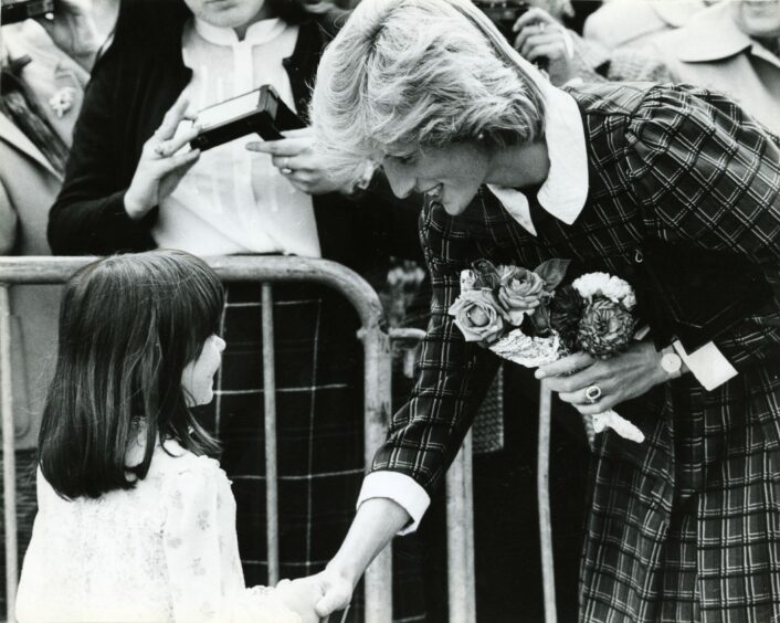 Princess Diana speaking to a young girl during her visit to the Keiller Sweet Factory in Mains Loan in 1983.