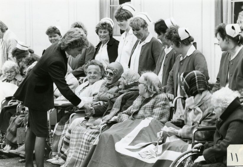 Princess Diana stops to speak to a group of older people at Roxburgh House in August 1986.