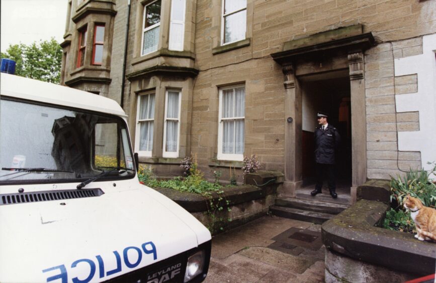 Police outside the flat at 52 Seafield Road where Mr Pollington was attacked.