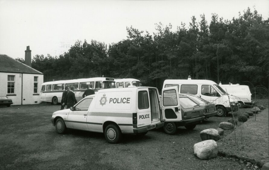 Police vehicles parked during a search of St Michael's Wood in Fife in December 1987. Image: DC Thomson.