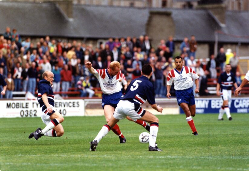 Jamie McGowan and Jim Duffy throw themselves at the feet of the advancing John Brown.