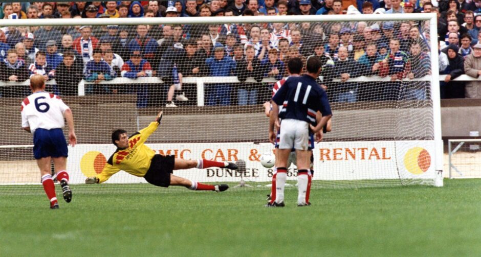 Rangers goalkeeper Ally Maxwell is sent the wrong way by the winning penalty, taken by striker Billy Dodds.