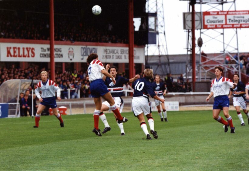 Dave McPherson wins a high ball for Rangers under pressure from Dundee's Ivo den Bieman and Billy Dodds.