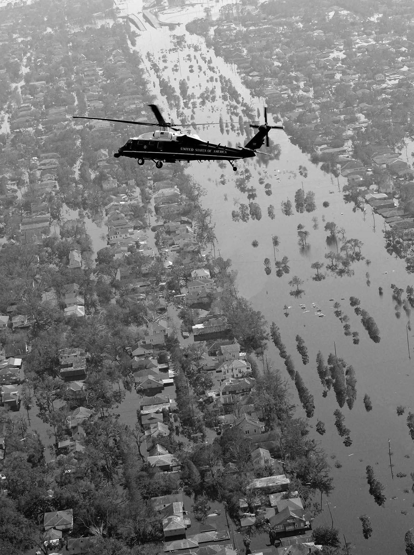 A helicopter flies over the devastation wrought by Hurricane Katrina.