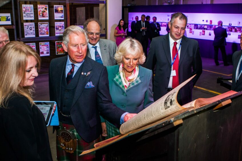 Struan Nimmo, right, awaits his big moment as the royal couple take a look through DC Thomson's archives.