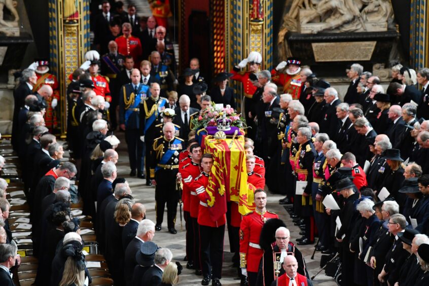 King Charles III and Camilla Queen Consort follow the coffin of Queen Elizabeth II.