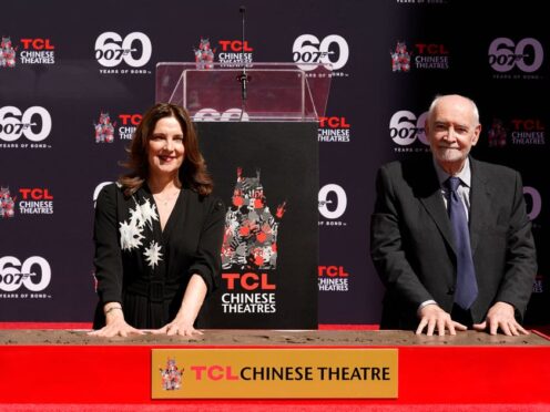 Michael G Wilson and Barbara Broccoli, producers of the James Bond film franchise, have their hands imprinted during a hand and footprint ceremony at the TCL Chinese Theatre in Los Angeles on Wednesday, Sept. 21, 2022. (AP Photo/Marcio Jose Sanchez)