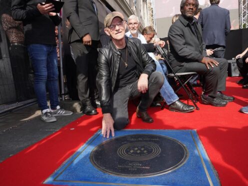 Woody Woodmansey next to a stone for David Bowie which was unveiled on the Music Walk of Fame at Camden, north London (Ian West/PA)