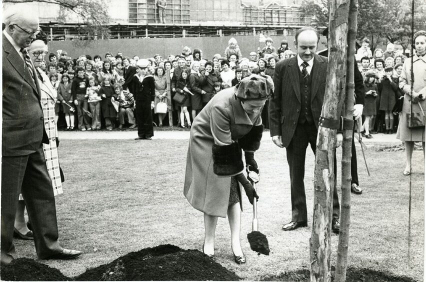 The Queen plants a tree outside Bells' Sports Centre during her royal visit to Perth in 1977.