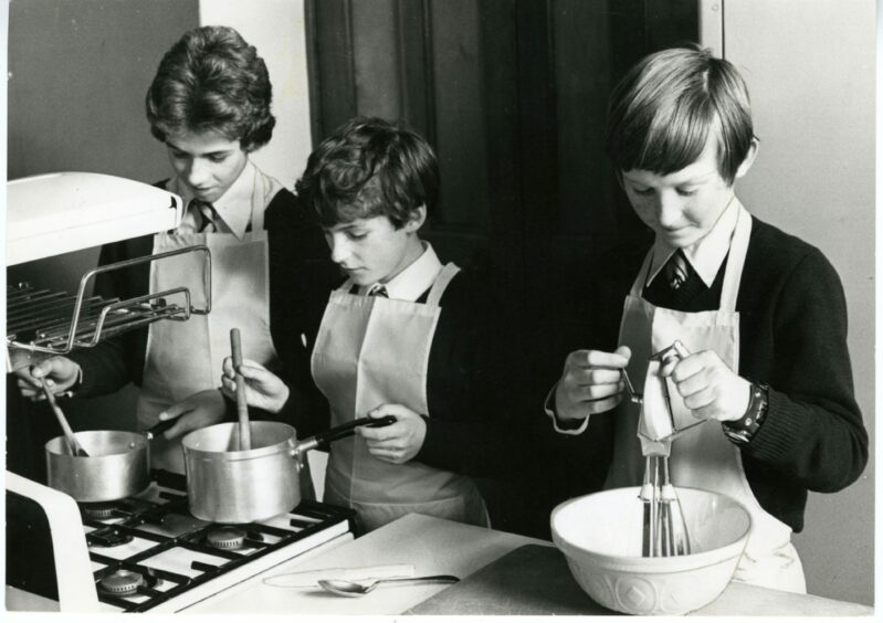 Graham Milne, McCallum Murray and Ewen Cameron learning how to cook.