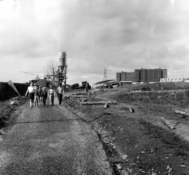 Whitfield children walking through the estate with the multi-storeys behind them in 1970. Image: DC Thomson.