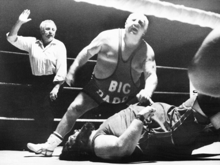 Big Daddy (nee Shirley Crabtree) takes down opponent Giant Haystacks during the golden era of wrestling.