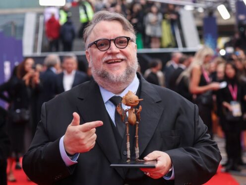 Director Guillermo del Toro poses with a model of the character Pinocchio (Viannry Le Caer/AP/PA)