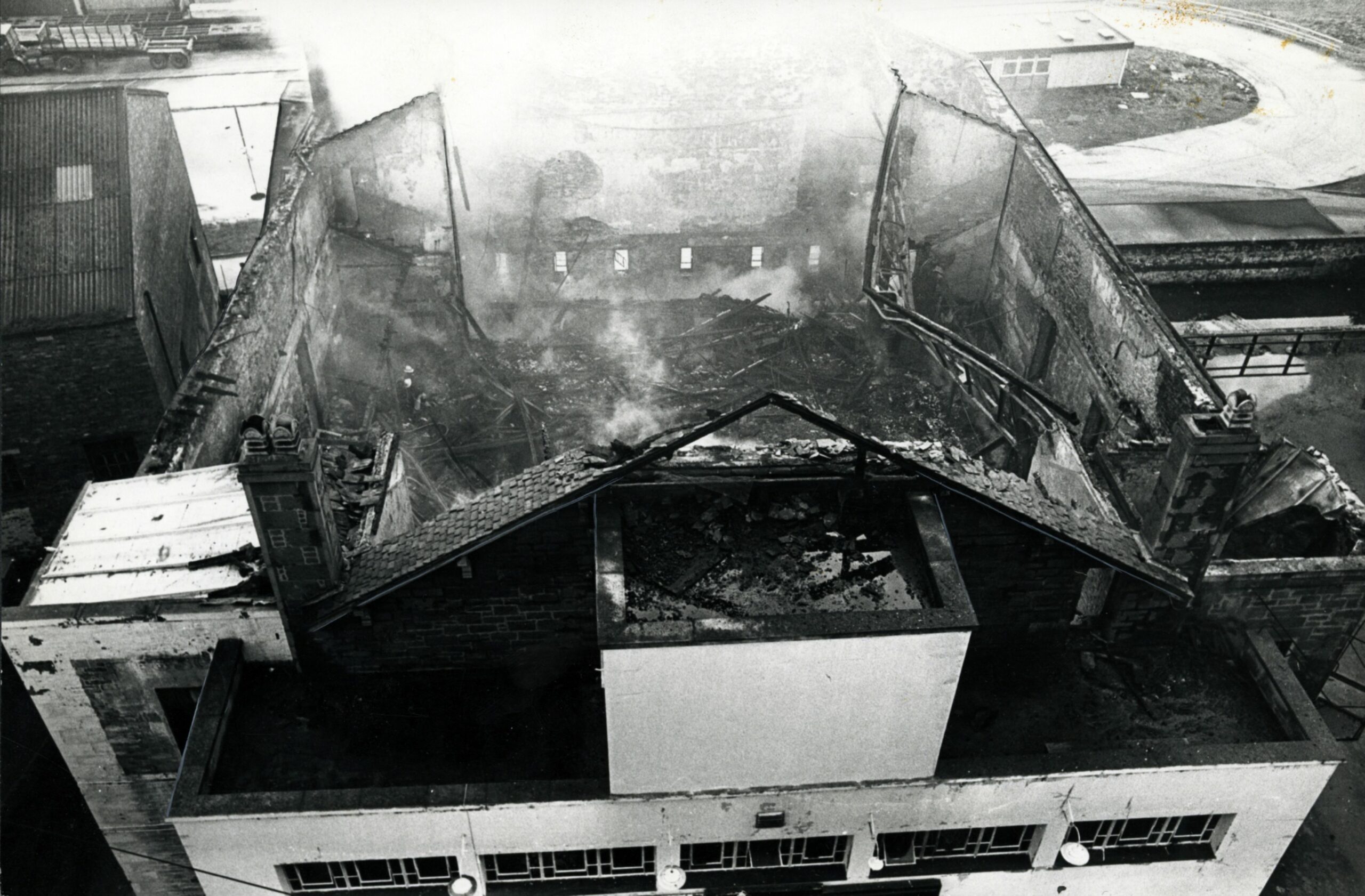 An overhead view of the smouldering shell of the building