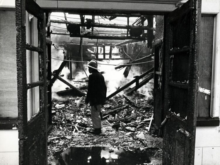 An interior view of the smouldering shell of the building.