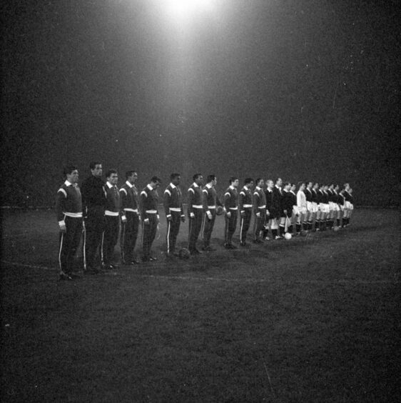 Both sides line up before the anthems were played at the start of the second-leg match at Dens. Image: DC Thomson.