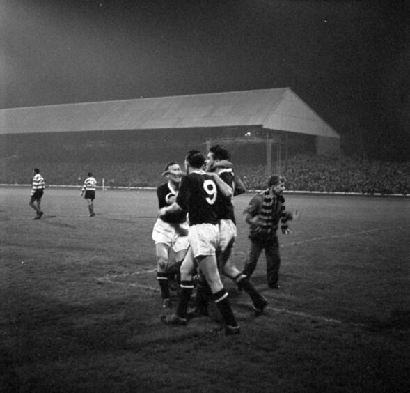 Dundee players celebrate on the pitch