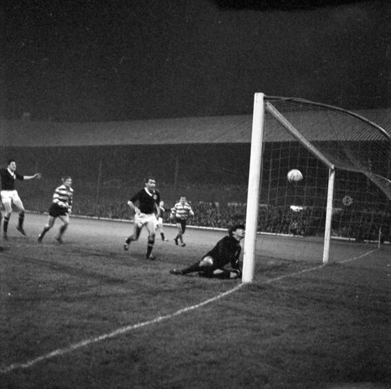 Cousin's header drops over the line from the bar for the goal that put Dundee 2-0 up.  Image: DC Thomson.
