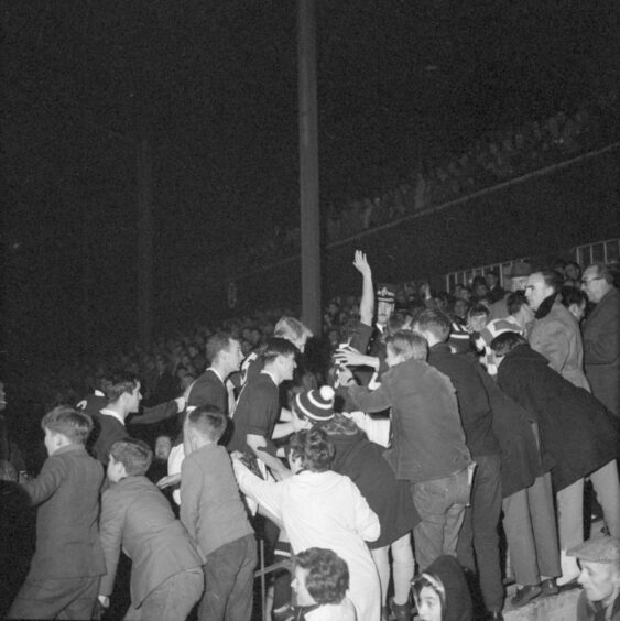 The Dundee fans cheer their heroes back up the tunnel at full-time.  Image: DC Thomson.