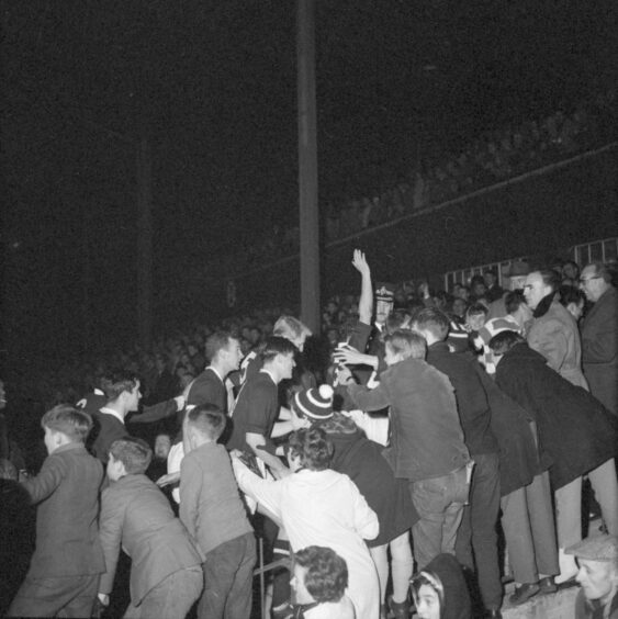 The Dundee fans cheer their heroes back up the tunnel at full-time. Image: DC Thomson.