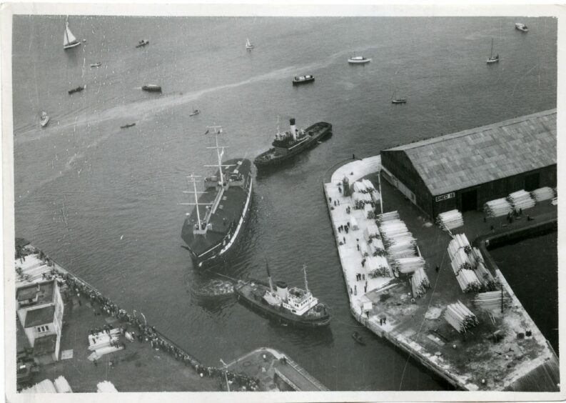 Aerial view of HMS Unicorn entering Camperdown Dock in October 1962 on the journey that could have ended with her sunk in the River Tay.