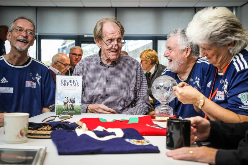 Ian Ure chats to George Laidlaw whilst showing off his football memorabilia